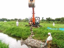 Stones linked with wires lifted by heavy equipment