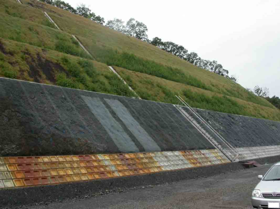 click to enlarge Photo 1 Brownish-colored slope with poor vegetation growth due to acidic water generation from rocks